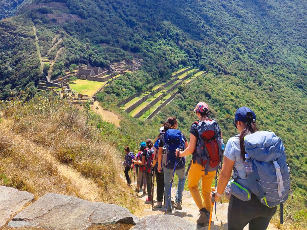 Inca Trail Sold Out? 2027 Alternatives Ranked by How Close They Feel 3 Hikers walking down a trail towards the Inca terraces of Choquequirao