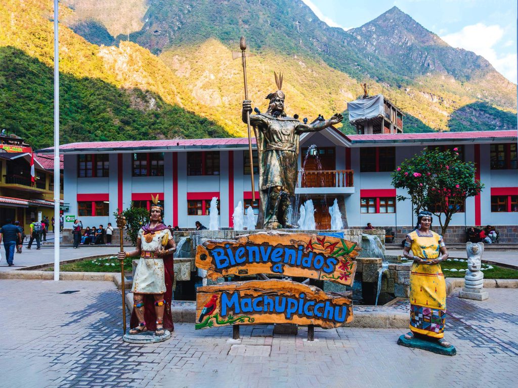 Machu Picchu Tickets 2027: Prices, When They Go on Sale and How to Buy 2 The main square of Machu Picchu town, Aguas Calientes, with a statue of the Inca Pachacutec and a welcome sign