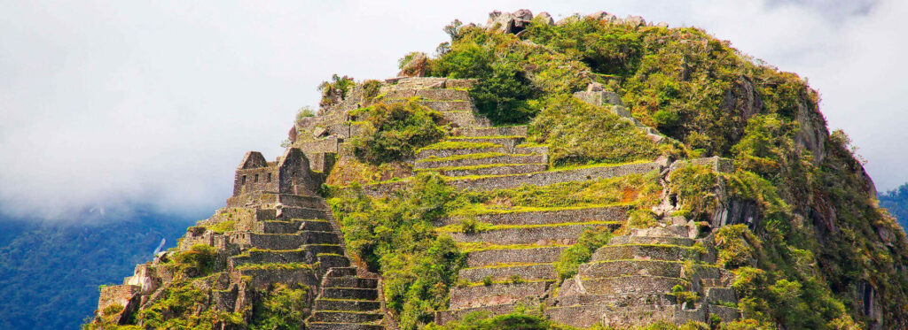 Huayna Picchu “Stairs of Death”: Is It Dangerous? A Section-by-Section Guide 2 Inca terraces clinging to the summit of Huayna Picchu among clouds
