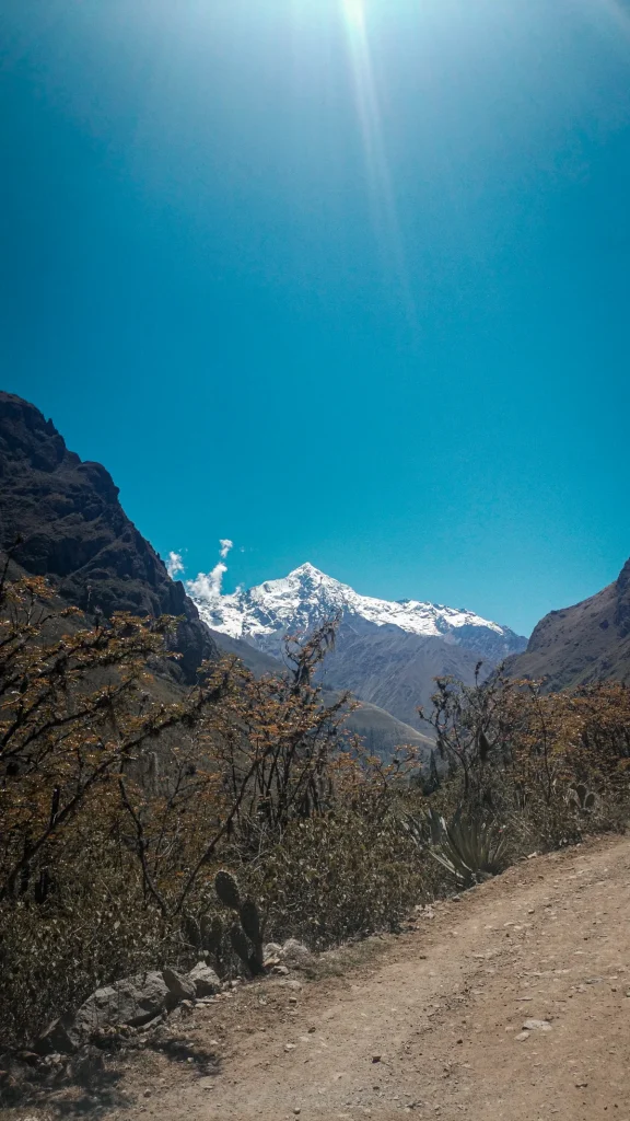 Inca Trail in August 2027: Weather, Wind, Holidays and When to Book 1 Dirt path leading toward a snow-capped peak on the Inca Trail