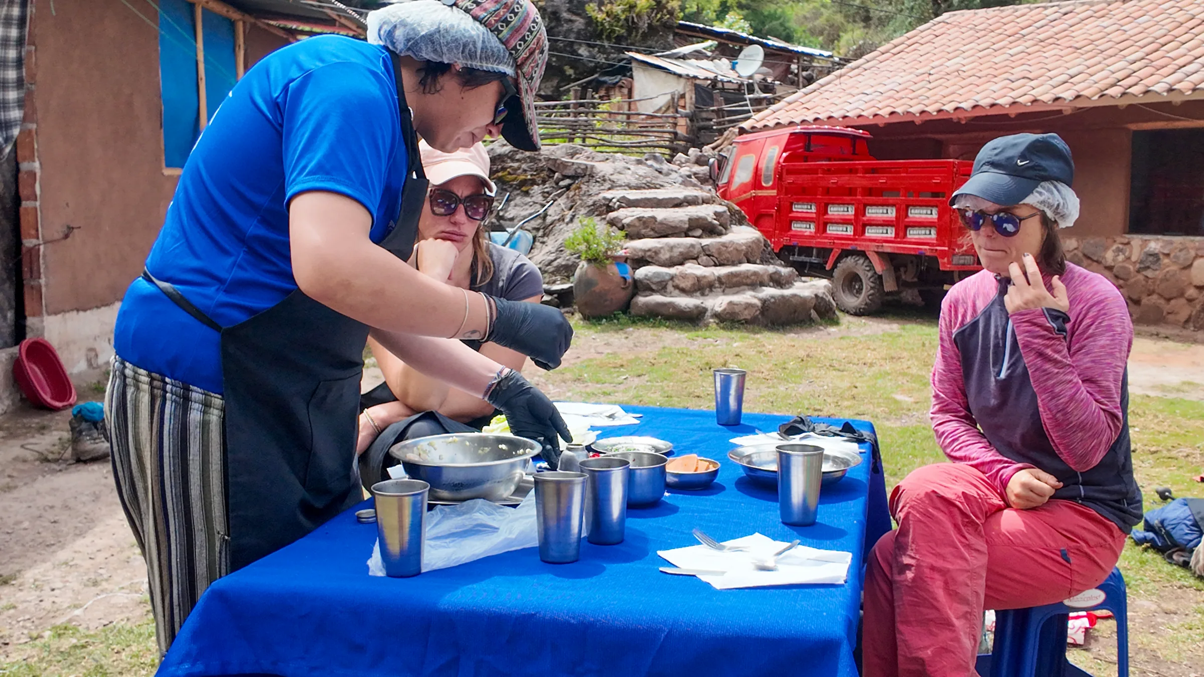Our cook serving soup to hikers at an outdoor table on the Lares trek