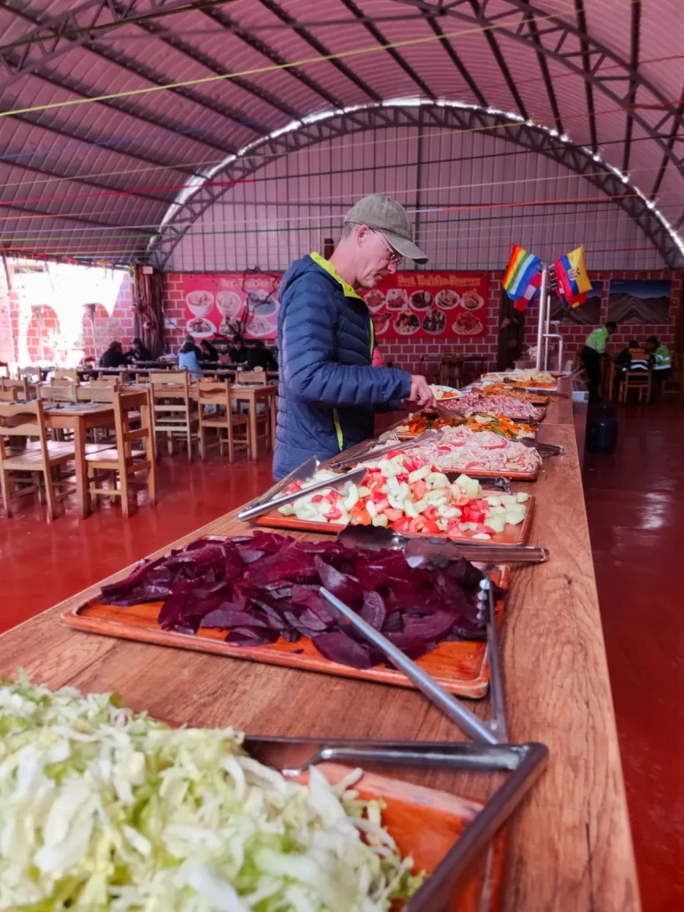 Traveler serving himself at the buffet lunch in a local restaurant on the Pallay Punchu tour