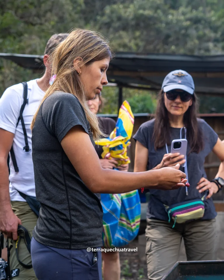 Hiker holding coffee cherries in a colorful woven cloth at a coffee farm on the Salkantay trek